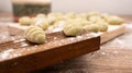 Selective focus shot of Gnocchis on a wooden dock against blurred background