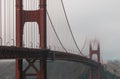 Selective focus shot of the Golden Gate Bridge covered in fog in San Francisco, California, USA Royalty Free Stock Photo