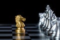 Selective focus shot of a golden knight chess pieces against the silver pawns Royalty Free Stock Photo