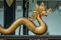 Selective focus shot of a golden snake statue with a blurred background