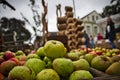 Selective focus shot of green apples with waterdrops in a wooden plate on outdoor background Royalty Free Stock Photo