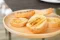 Selective focus shot of grilled garlic bread sliced with butter and spice looks delicious with yellow and brown color for snack or