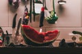 Selective focus shot of a half cut watermelon with a knife in it