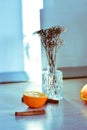 Selective focus shot of half an orange, cinnamons, dry roses, and decorative branches in vases Royalty Free Stock Photo