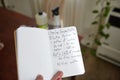 Selective focus shot of a hand holding cleaning concentrate handwritten recipe