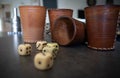 Selective focus shot of handmade leather dice cups with five dices on the table Royalty Free Stock Photo