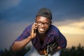 Selective focus shot of a handsome smiling African-American male talking on the phone