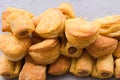 Selective focus shot of a heap of delicious sausages and cheese in the dough