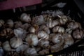 Selective focus shot of a heap of garlic in basket for sale at a market
