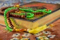 Selective focus shot of the Holy Koran book with rosary beads  on the carpet Royalty Free Stock Photo