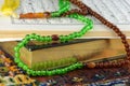 Selective focus shot of the Holy Koran book with rosary beads  on the carpet Royalty Free Stock Photo