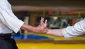 Selective focus shot of human hands showing Aikidoka during Aikido practice Royalty Free Stock Photo