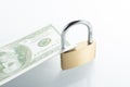 Selective focus shot of a hundred-dollar banknote and a padlock - concept of financial security