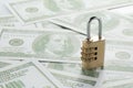 Selective focus shot of hundred-dollar banknotes and a padlock - concept of financial security