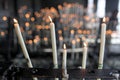 Selective focus shot of lighting candles in the church
