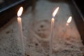 Selective focus shot of lighting candles in a church