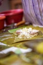 Selective focus shot of making Cassava Suman in a banana leaf Royalty Free Stock Photo