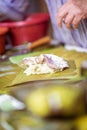 Selective focus shot of making Cassava Suman in a banana leaf Royalty Free Stock Photo