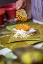 Selective focus shot of making Cassava Suman in a banana leaf Royalty Free Stock Photo