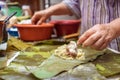 Selective focus shot of making Cassava Suman in a banana leaf Royalty Free Stock Photo