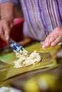 Selective focus shot of making Cassava Suman in a banana leaf Royalty Free Stock Photo