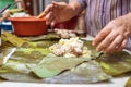 Selective focus shot of making Cassava Suman in a banana leaf Royalty Free Stock Photo