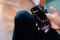 Selective focus shot of male hand holding a smartphone with cryptocurrencies statistics on screen