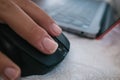 Selective focus shot of a male hand using a wireless computer mouse Royalty Free Stock Photo