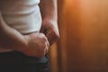 Selective focus shot of a man undoing his pants Royalty Free Stock Photo