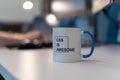 Selective focus shot of a mug with a printed text of CSS IS AWESOME with a blurred background