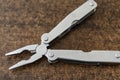 Selective focus shot of a multitool leatherman on brown background Royalty Free Stock Photo