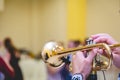 Selective focus shot of a musician playing the trumpet while people are dancing to the music Royalty Free Stock Photo