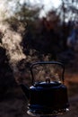 Selective focus shot of an old aluminum kettle with boiling water Royalty Free Stock Photo