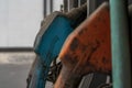 Selective focus shot of an old blue gas pump nozzle in a gasoline station Royalty Free Stock Photo