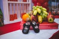 Selective focus shot of a pair of baby shoes by some fruits Royalty Free Stock Photo