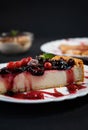 Selective focus shot of a piece of cheesecake with berries