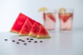 Selective focus shot of pieces of watermelon, seeds, and watermelon juice