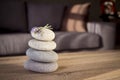 Selective focus shot of a pile of rocks on the table with a couch on the background Royalty Free Stock Photo
