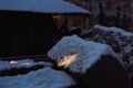 Selective focus shot of a pile of tree branches covered with snow