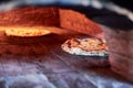 Selective focus shot of a pizza baking in a traditional stone oven Royalty Free Stock Photo