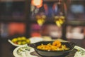 Selective focus shot of plates of shrimp and olives and two wine glasses on a table in a restaurant Royalty Free Stock Photo