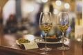 Selective focus shot of plates of shrimp and olives and two wine glasses on a table in a restaurant Royalty Free Stock Photo