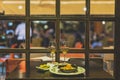 Selective focus shot of plates of shrimp and olives and two wine glasses on a table in a restaurant Royalty Free Stock Photo