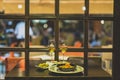 Selective focus shot of plates of shrimp and olives and two wine glasses on a table in a restaurant Royalty Free Stock Photo