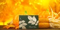 Selective focus shot of pumpkins, corns, autumn leaves and a note - Thanksgiving concept