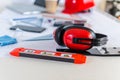Selective focus shot of red balance ruler and noise-canceling headphones on a working desk