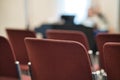 Selective focus shot of red, empty chairs in a church against a blurry background Royalty Free Stock Photo