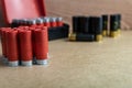 Selective focus shot of red shotgun ammo on a brown surface