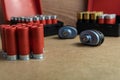 Selective focus shot of red shotgun ammo on a brown surface