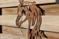 Selective focus shot of a rustic metal horse pattern on a wooden background